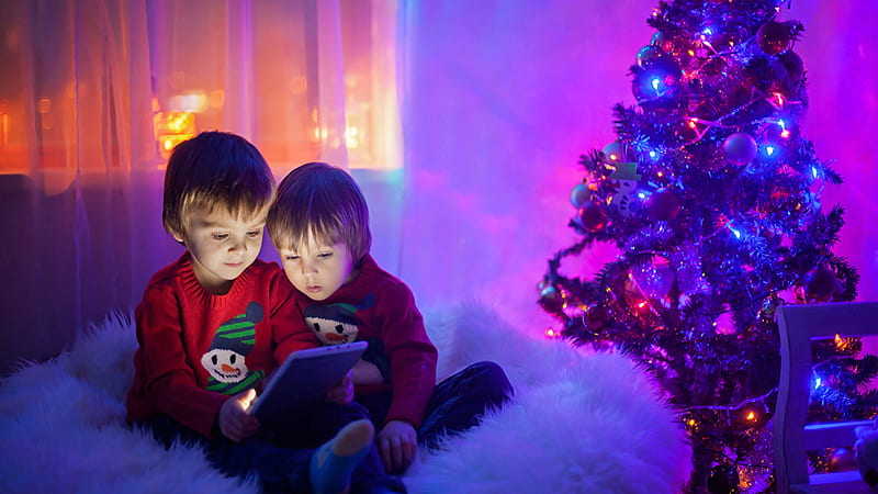 Two Cute Boys Are Seeing Tablet Wearing Red Dress Sitting On White Fur Cloth Near Decorated Christmas Tree Cute, HD wallpaper