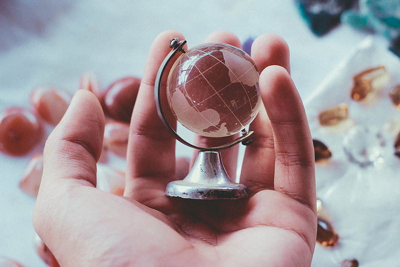 person holding gray metal framed desk globe paper weight, HD wallpaper