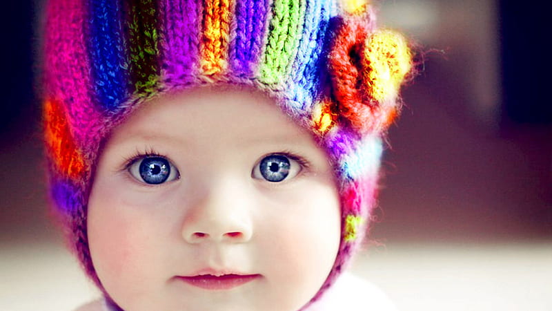 Cute Dark Blue Eyes Baby Is Wearing Colorful Knitted Wool Cap In A Blur Background Cute, HD wallpaper