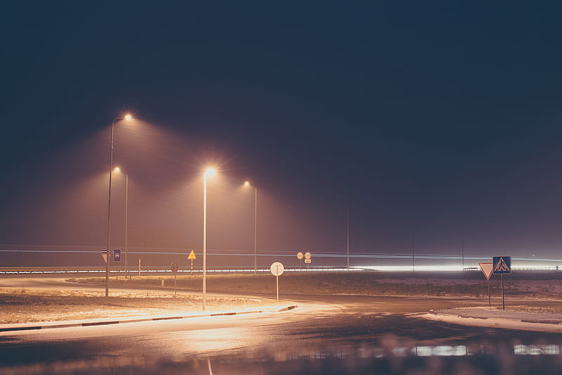 concrete road with turned on post lamp lights at nighttime, HD wallpaper