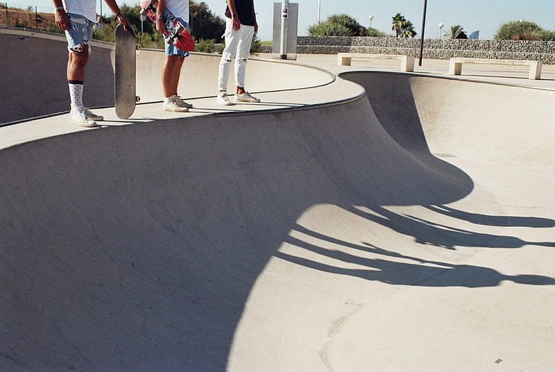 three skaters standing on skateboard concrete ramp with shadow at daytime, HD wallpaper