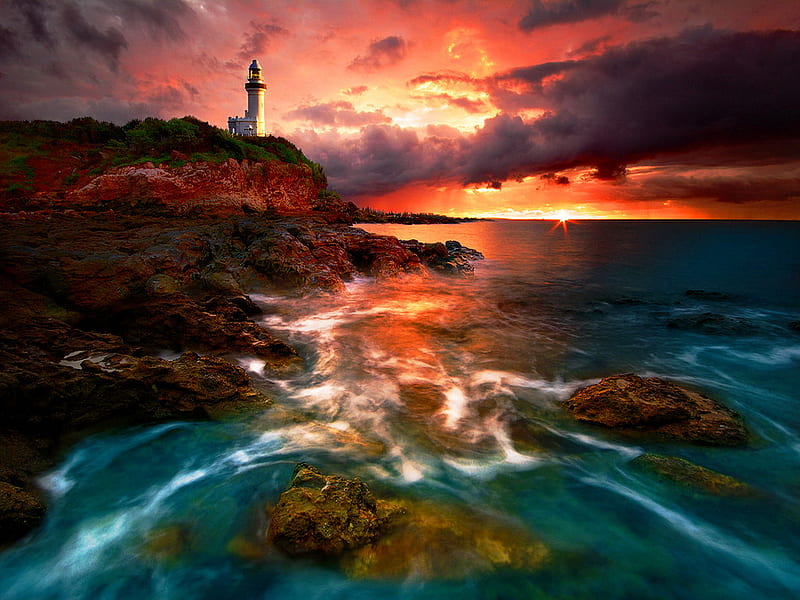 Lighthouse at sunset, rocks, sun, sunset, waves, sky, clouds, lighthouse, sea, beach, sundown, stones, water, nature, reflection, coast, HD wallpaper