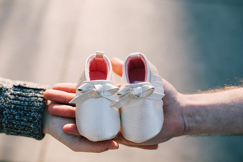 two person holding pair of baby's shoes, HD wallpaper