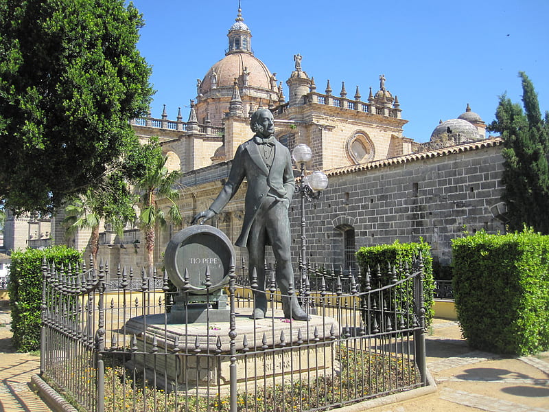 Church in Jerez de la Frontera Spain, fence, man, church, sky, spain, tree, leaves, monument, statue, sherry, blue, HD wallpaper