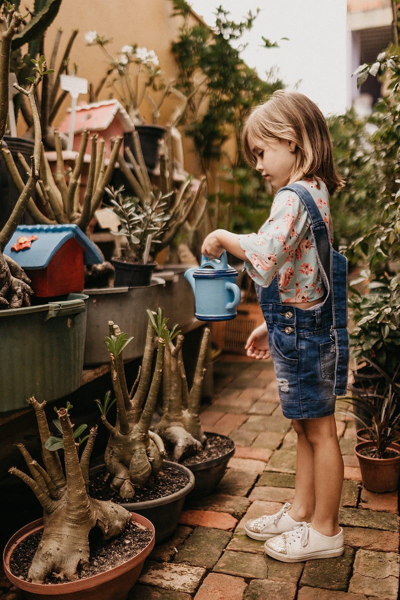 girl wearing blue romper holding teal watering can, HD phone wallpaper