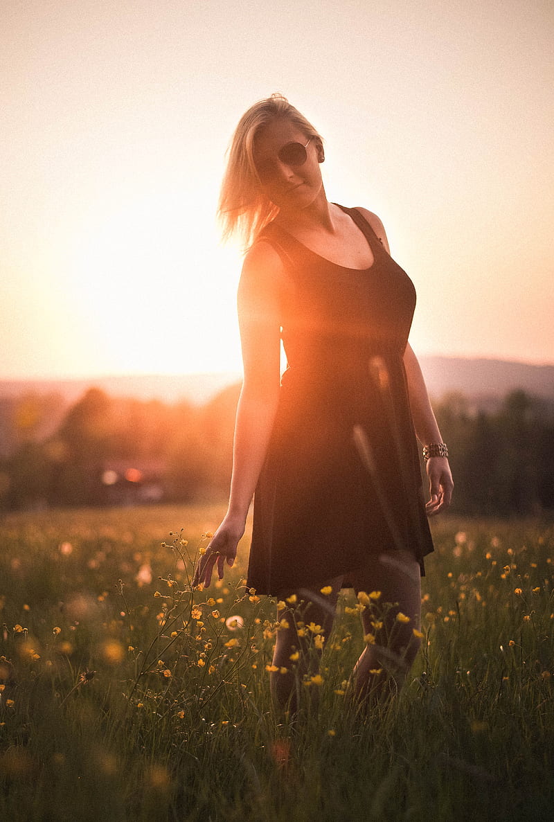woman wearing black scoop-neck mini dress surrounded by flowers during sunset, HD phone wallpaper