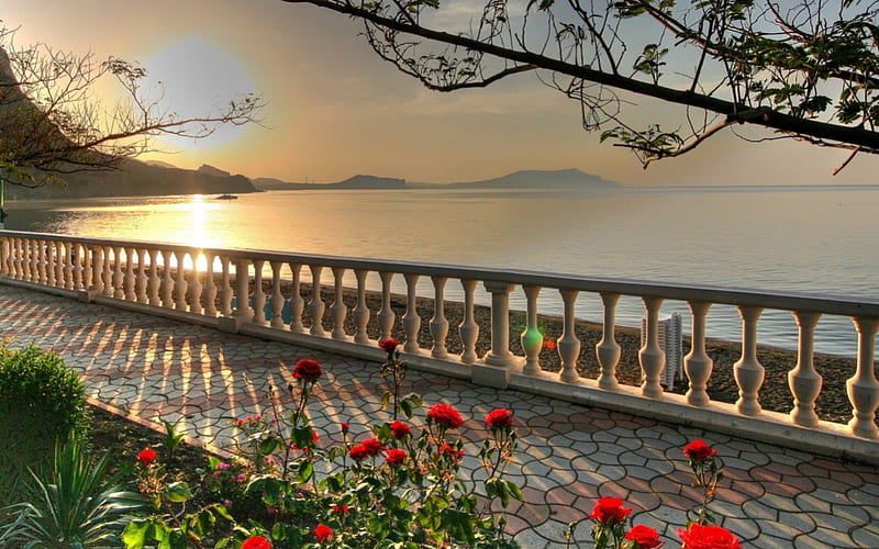 Splendid view of the ocean, red, balcony, ocean, sunset, trees, brillant sun, stones, water, walkway, plants, railing, flowers, HD wallpaper