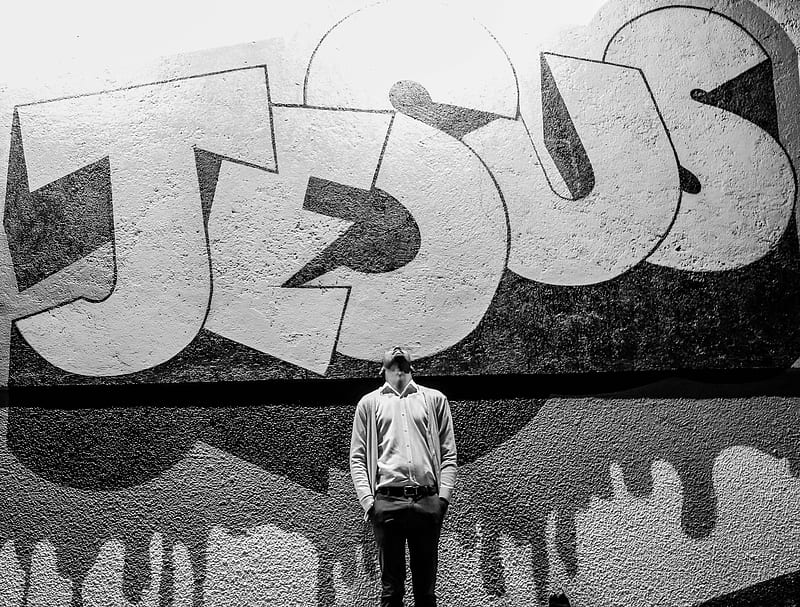 grayscale graphy of a man standing in front of a Jesus graffiti, HD wallpaper