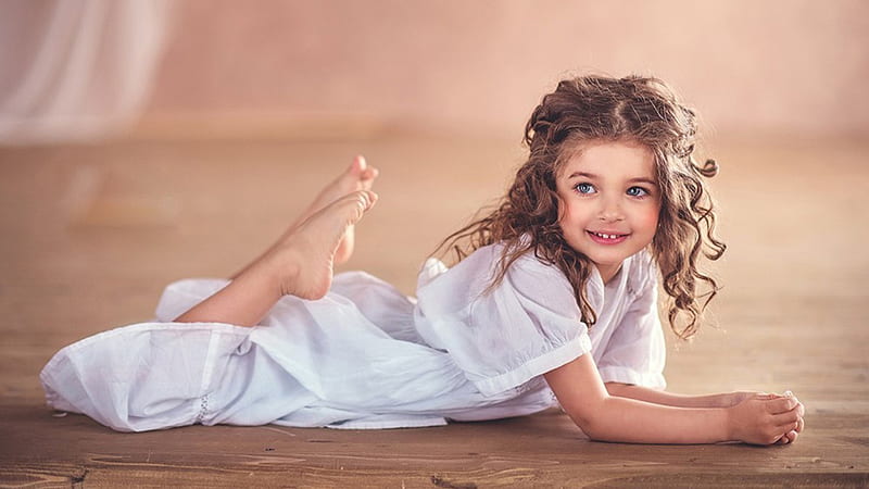 Grey Eyes Cute Little Girl Is Lying Down On Floor Wearing White Dress In Blur Background Cute, HD wallpaper