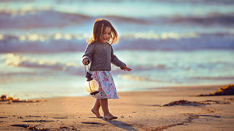 Cute Little Girl With Lantern Is Walking On Beach Sand Wearing White Flowers Printed Skirt And Black Top Cute, HD wallpaper