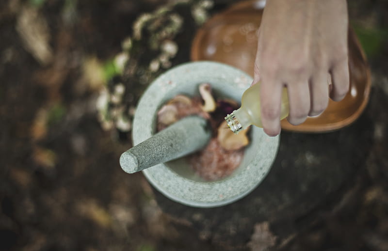 high angle of person pouring liquid from bottle inside mortar and pestle, HD wallpaper