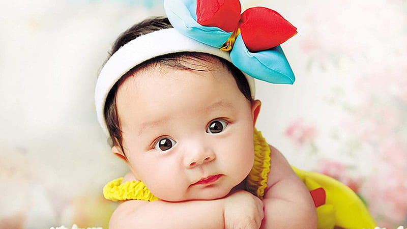 Closeup View Of Cute Baby Girl Child Is Lying Down On Bed Wearing ...