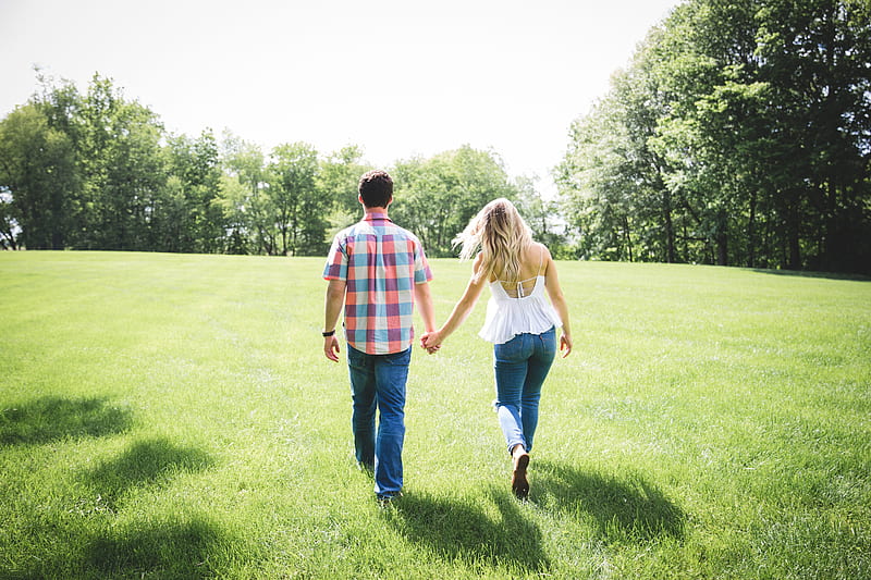 man and woman walking on green grass field surrounded with trees, HD wallpaper