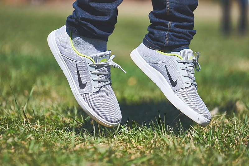 pair of gray Nike low-top sneakers hanging on green grass, HD wallpaper
