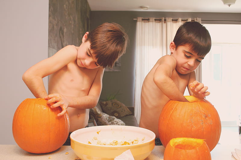 two boys holding pumpkins on table inside house, HD wallpaper