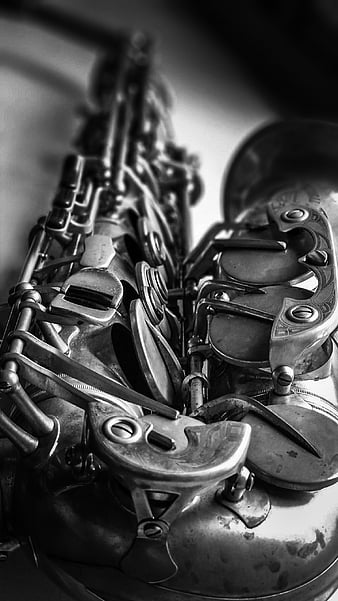 close up of Young Saxophone Player hands playing alto sax musical  instrument over a black background - CLOSLER - CLOSLER