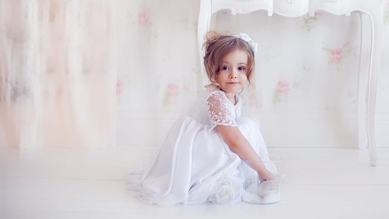 Cute Little Girl Is Sitting On Floor In White Background Wearing White ...