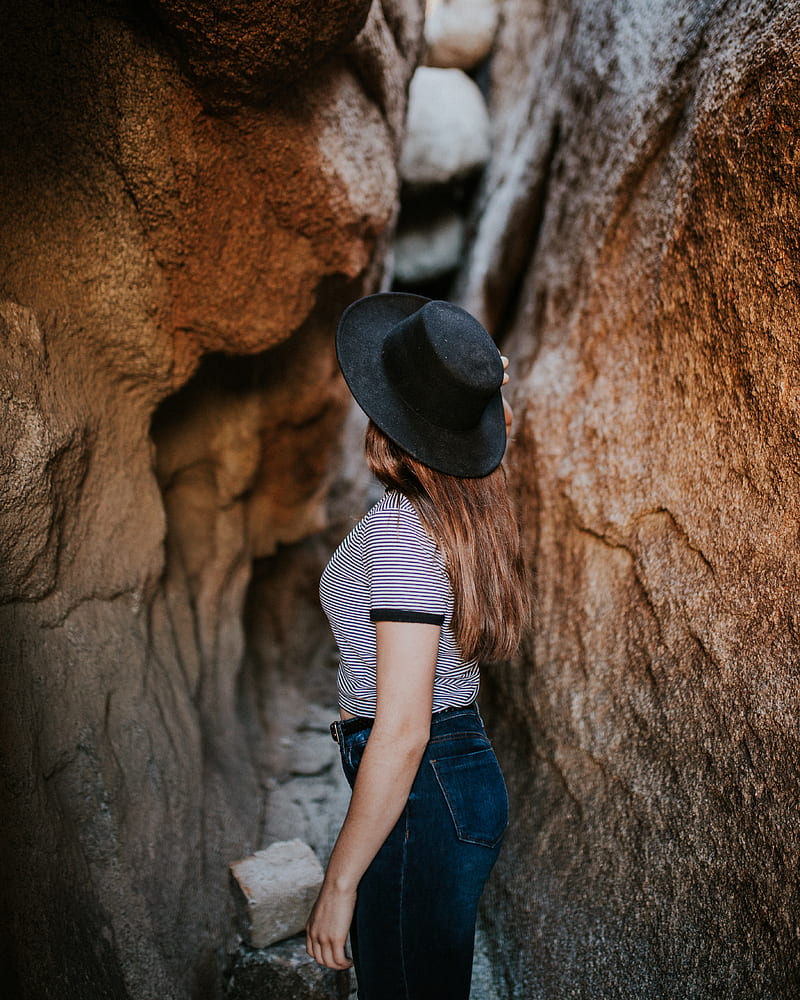 woman standing between narrow cave pathway, HD phone wallpaper