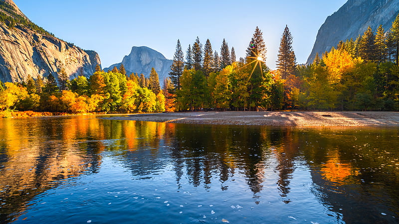 Green Yellow Orange Autumn Trees With Sunlight In Mountain Blue Sky ...