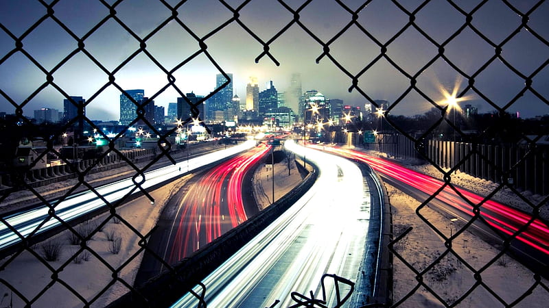 View of city way through cut fence during winter, crafted, fence, city, way, car, road, winter, night, HD wallpaper
