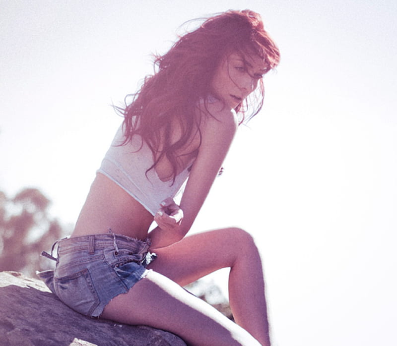 Zoe Voss with red hair (not natural), long, denim cut offs, white tank top, sitting on rock, red highlights, HD wallpaper