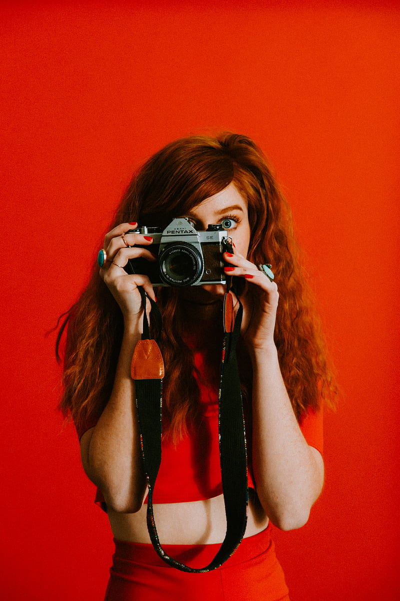 woman in red top and bottoms holding Pentax camera, HD phone wallpaper