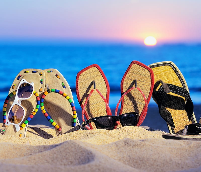 The sea, beach, sand and women's accessories: pink flip-flops