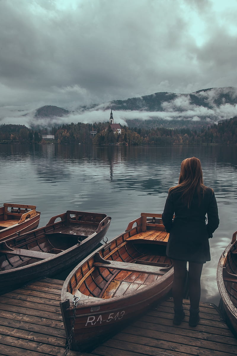 boat, women, water, mountains, Slovenia, Lake Bled, rear view, black coat, coats, brunette, straight hair, black clothing, long hair, Black clothes, standing, jetty, young woman, HD phone wallpaper