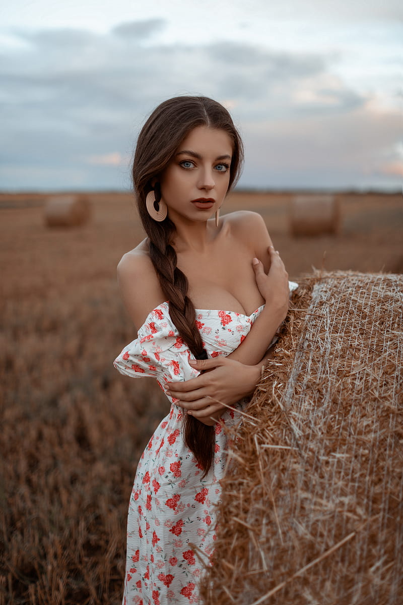 Anna Sazonova, women, model, brunette, ponytail, long hair, braided hair, looking at viewer, red lipstick, parted lips, bare shoulders, cleavage, arms crossed, hay, depth of field, portrait display, field, dress, outdoors, women outdoors, haystacks, summer dress, HD phone wallpaper