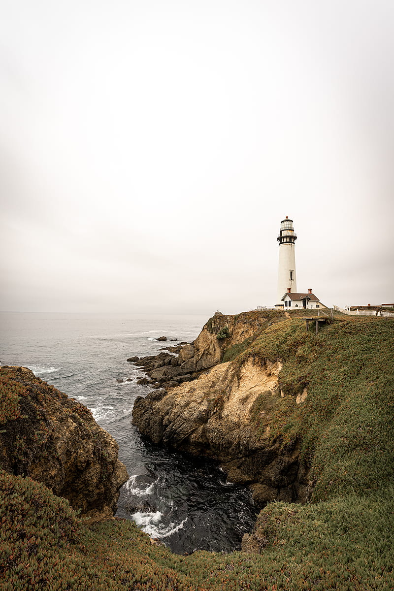 white lighthouse on brown rock formation near body of water during daytime, HD phone wallpaper