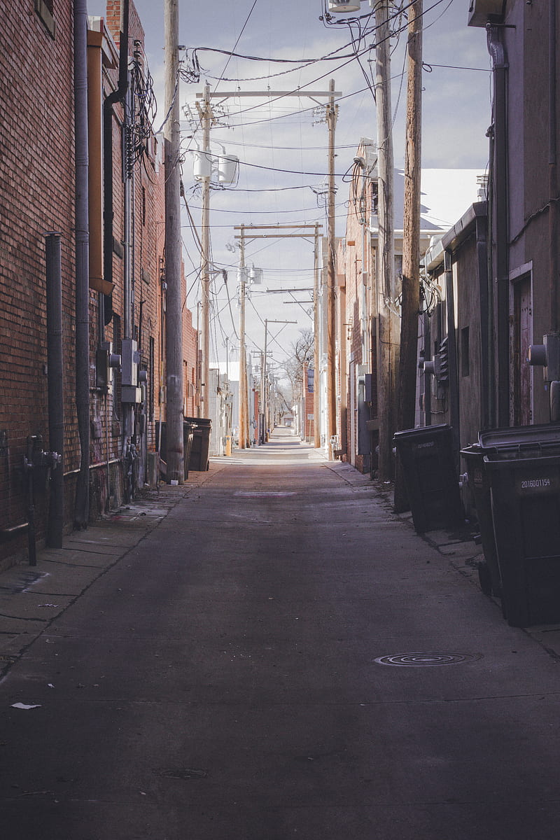 empty street between brown brick buildings during daytime, HD phone wallpaper
