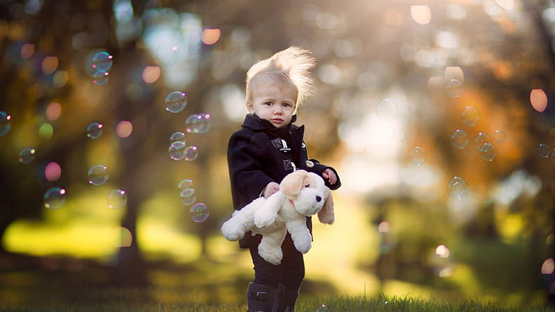 Cute Little Boy With Soft Toy Is Standing In Bubbles Bokeh Background Wearing Black Dress Cute, HD wallpaper