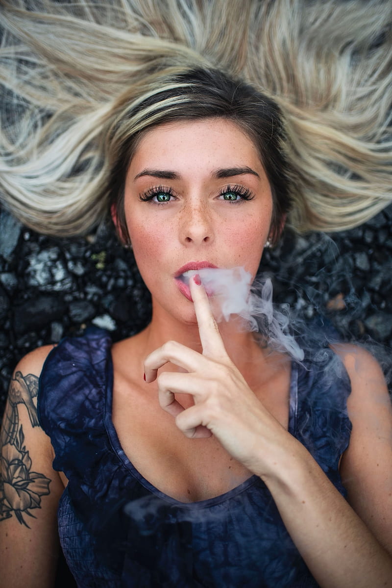 women, looking at viewer, blonde, smoke, tattoo, face, open mouth, painted nails, green eyes, portrait display, lying on back, HD phone wallpaper