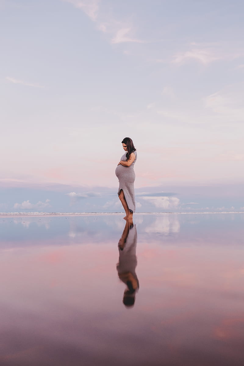 pregnant woman standing on calm body of water, HD phone wallpaper