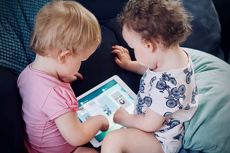two toddlers sitting on sofa while using tablet computer, HD wallpaper