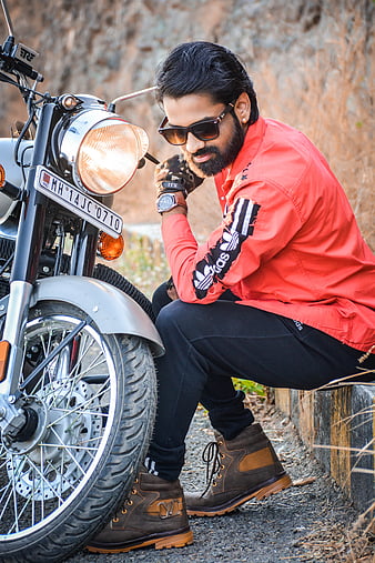 Handsome Rider Guy With Beard And Mustache Posing While Put On Black Moto  Glasses Near Classic Style Biker Cafe Racer Motorcycle. Bike Custom Made In  Vintage Garage. Brutal Fun Urban Lifestyle. Stock
