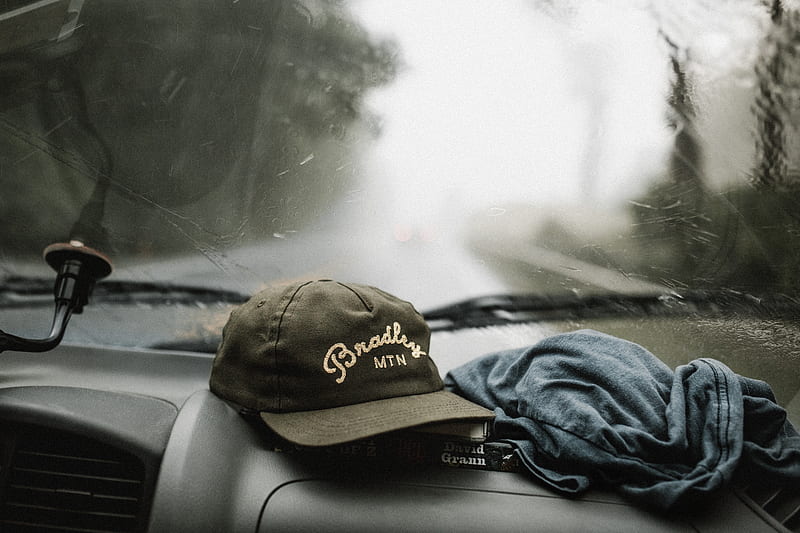 black and white baseball cap near grey shirt on top of glove compartment inside car, HD wallpaper