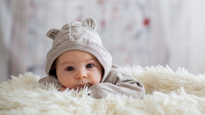 Cute Baby Is Lying Down On Sandal Woolen Bed Wearing Bunny Cap Cute, HD wallpaper