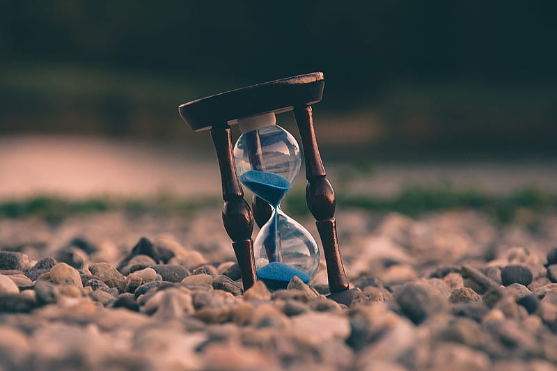 selective focus of brown and blue hourglass on stones, HD wallpaper