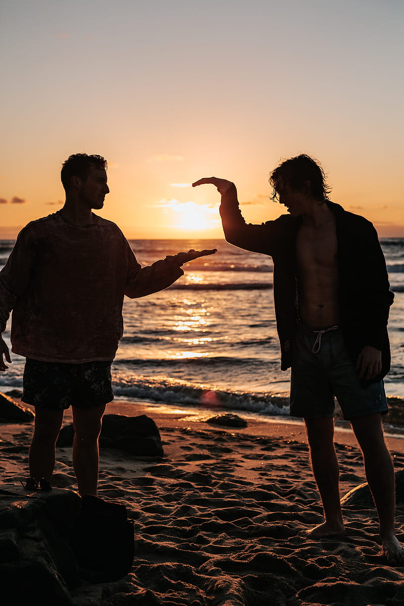 close-up of two men shaking hands near beach at sunset, HD phone wallpaper