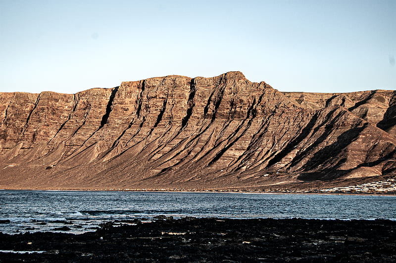 Brown Rock Formation Near Body Of Water During Daytime Hd Wallpaper