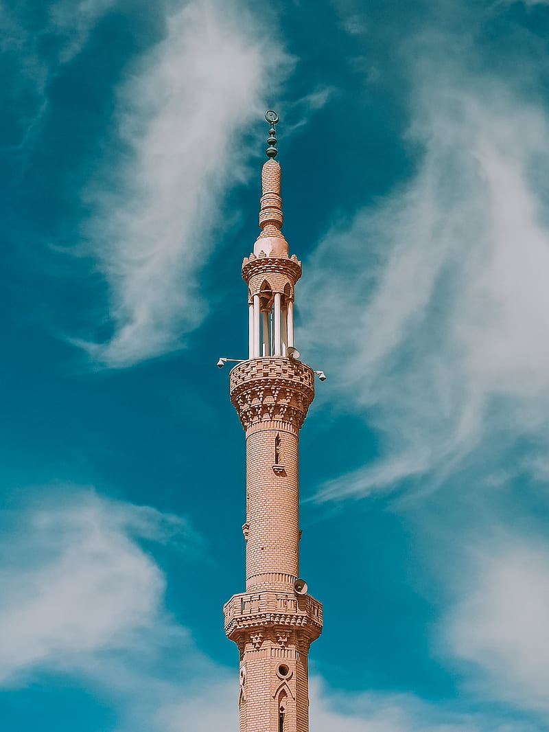 From below scenery view of aged high masonry tower with columns and decorative elements on walls and pointed spire on top with lamps under sky with clouds in daylight, HD phone wallpaper