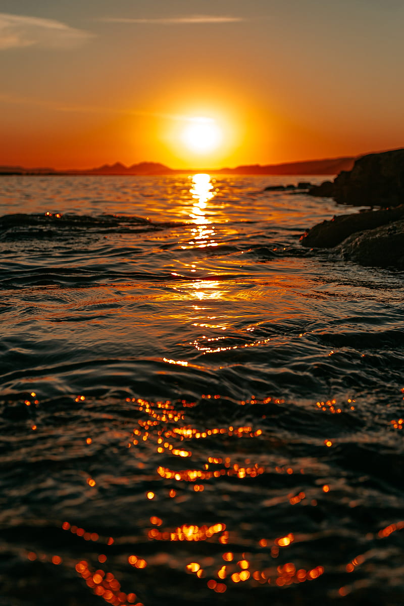 Puesta de sol, mar, resplandor, rocas, cielo, Fondo de pantalla de teléfono  HD | Peakpx