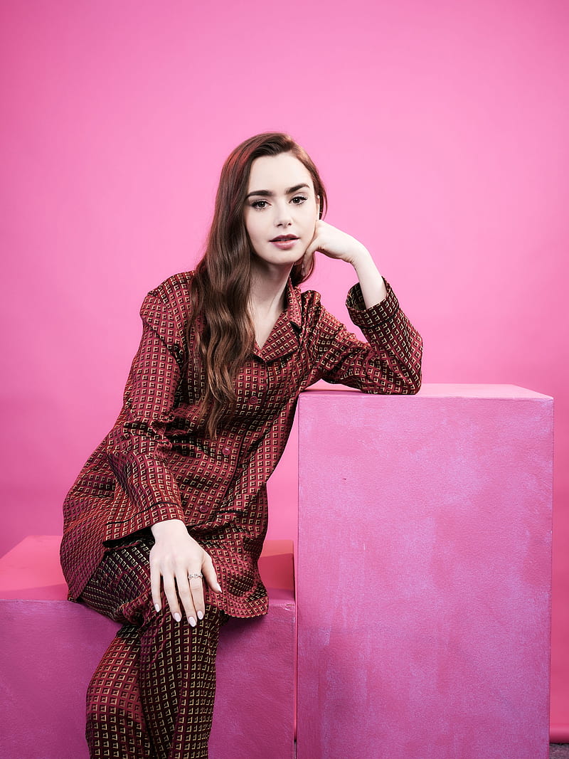 Lily Collins, women, model, actress, brunette, long hair, dark hair, pink background, simple background, sitting, red clothing, HD phone wallpaper