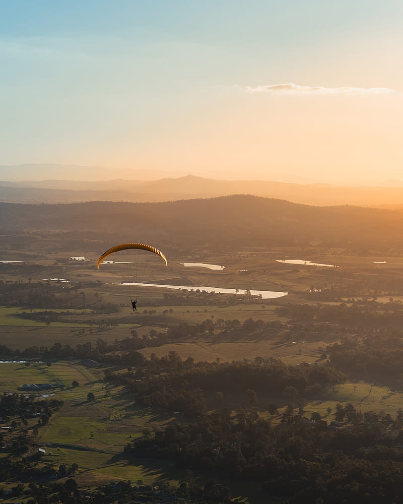 person paragliding above countryside during daytime, HD phone wallpaper