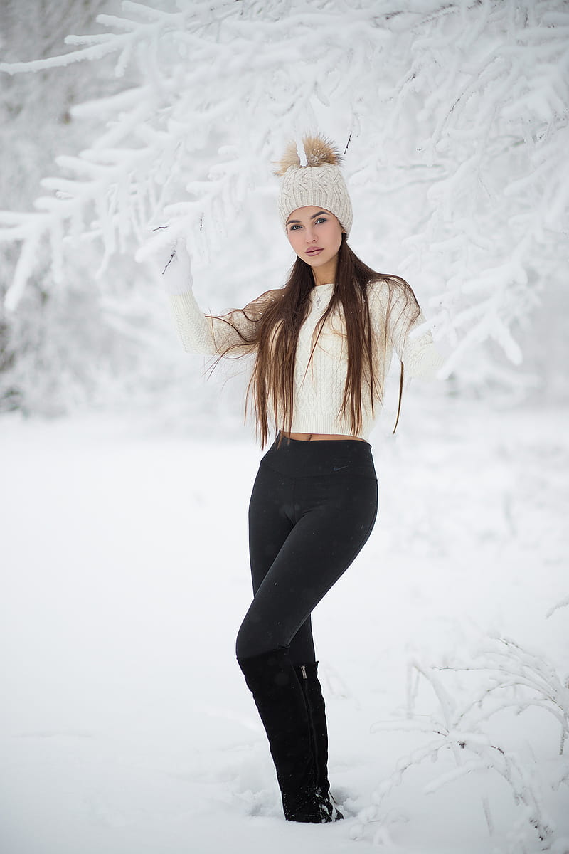 portrait display, white, brunette, women outdoors, snow, winter, pants, looking at viewer, long hair, leggings, white sweater, sweater, Wool cap, black pants, straight hair, white gloves, gloves, necklace, standing, black boots, knee-high boots, arms up, white cap, woolly hat, young woman, tight clothing, HD phone wallpaper