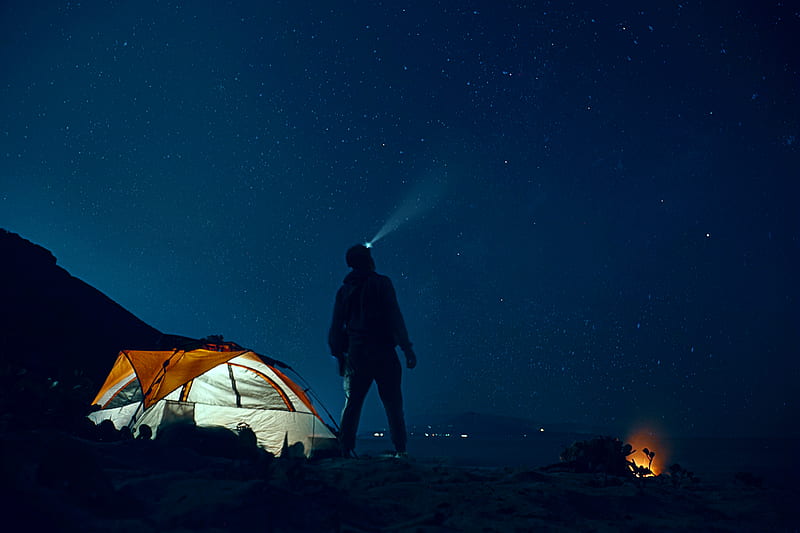 man standing beside camping tent wearing headlamp during nighttime, HD wallpaper