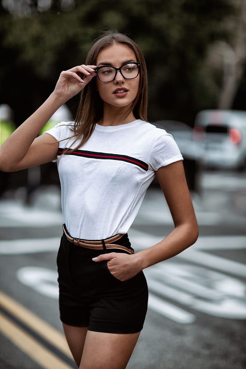 women outdoors, brunette, women with glasses, bokeh, portrait display, women, urban, street, looking away, high waisted short, depth of field, Christopher Rankin, hands in pockets, looking into the distance, Public, black pants, T-shirt, Theresa Grant, HD phone wallpaper
