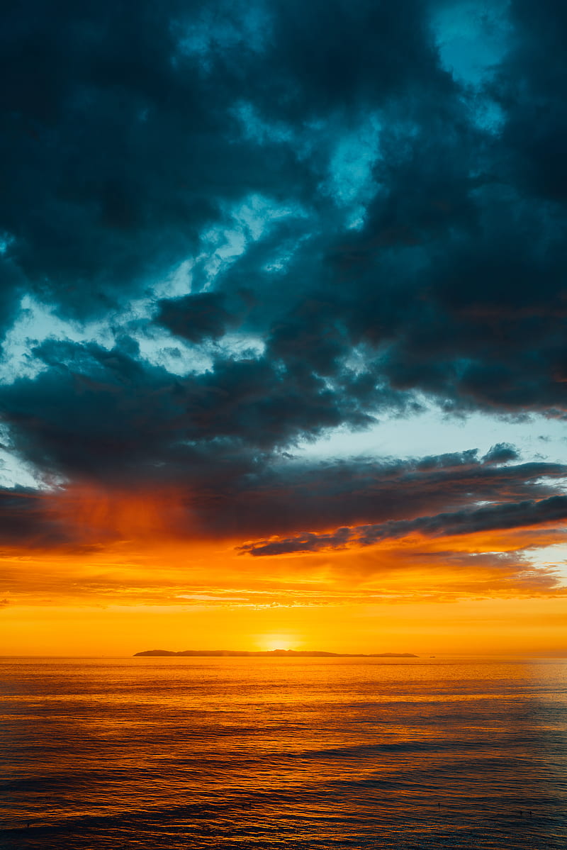 green and black clouds partly covering orange sky over sea at sunset, HD phone wallpaper