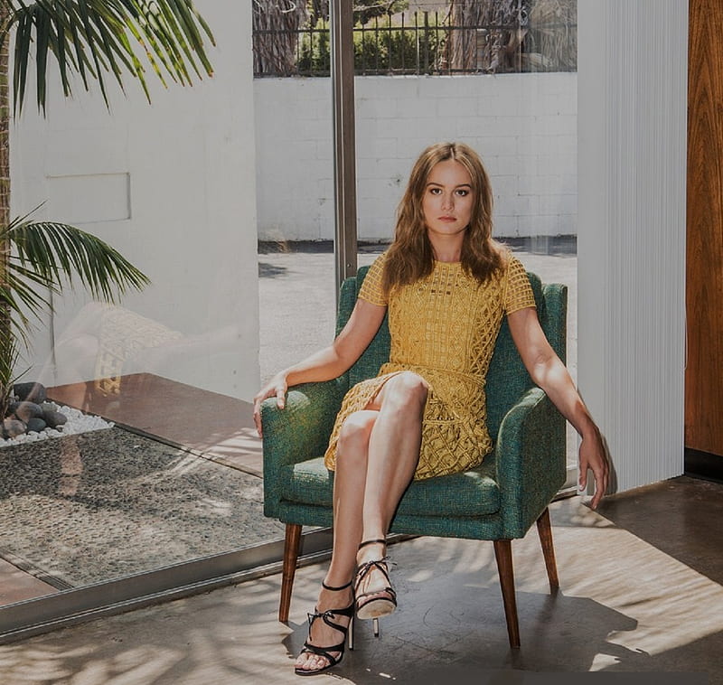 Brie Larson, brunette, large windows, yellow mustard dress, roman style heels, sitting in arm chair, knitted, HD wallpaper
